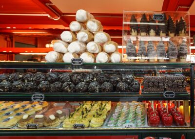 Delicious assortment of pastries and sweets on display in a vibrant bakery. Perfect temptation for dessert lovers.