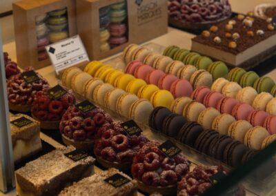 Indulge in a colorful array of macarons and pastries at a Parisian patisserie, showcasing French culinary artistry.